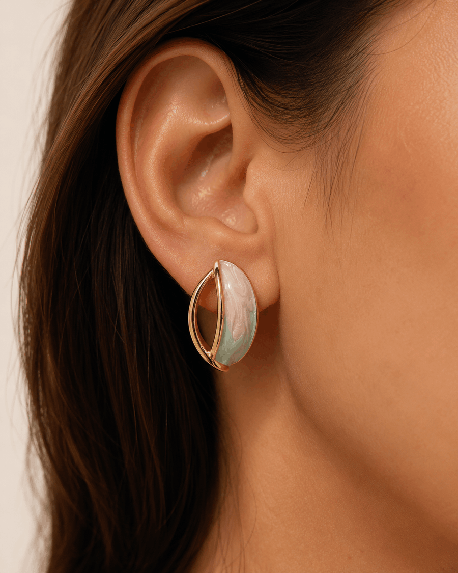 Pastel Orbit gold-tone hoop earrings with pink and mint enamel worn by a model
