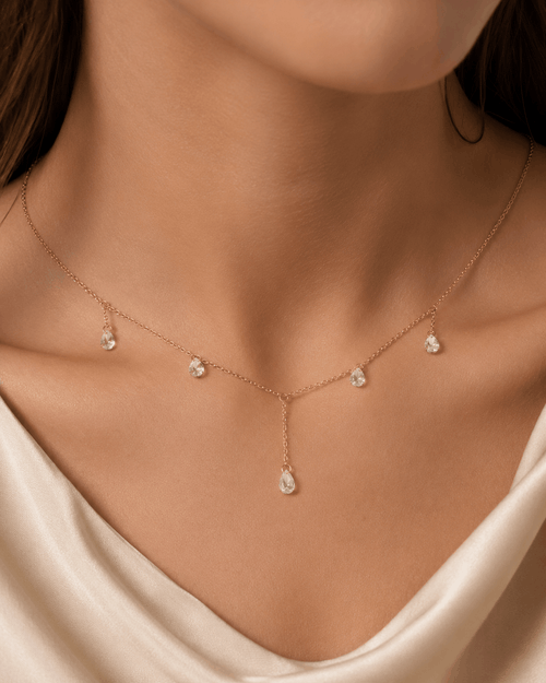 Celeste Glow gold-tone crystal drop necklace worn by a model
