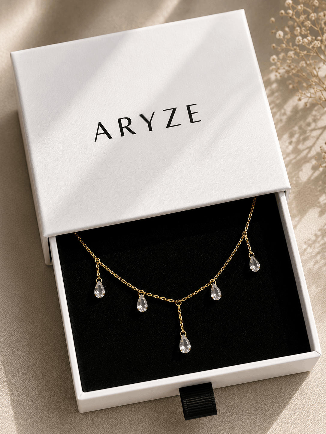 Celeste Glow gold-tone crystal drop necklace presented in the branded Aryze gift box