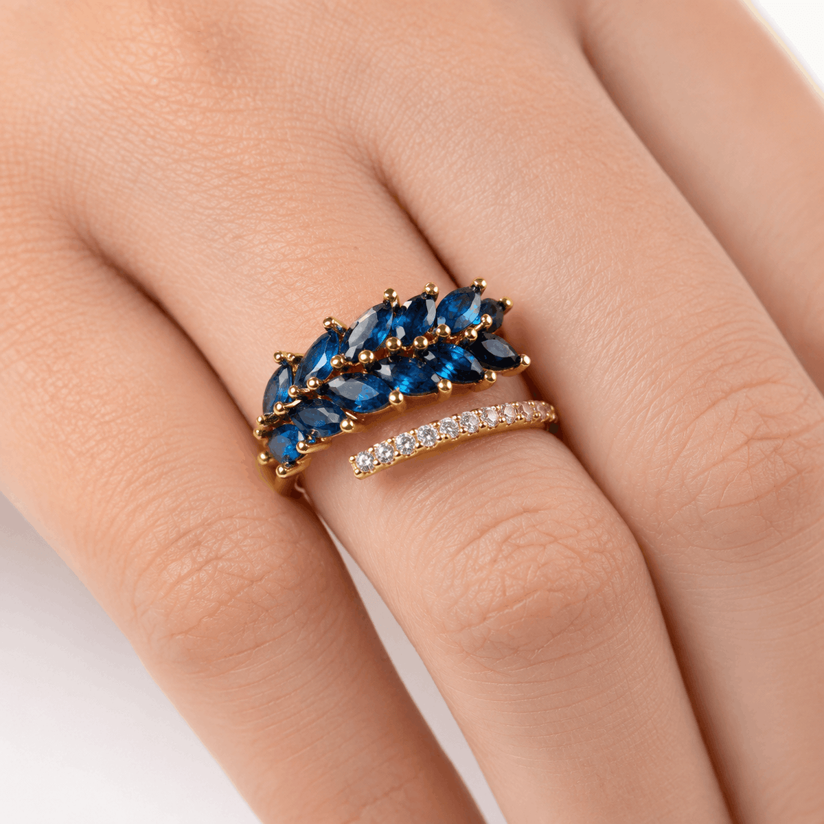 Midnight Aura gold-tone ring with blue marquise cubic zirconia worn by a model